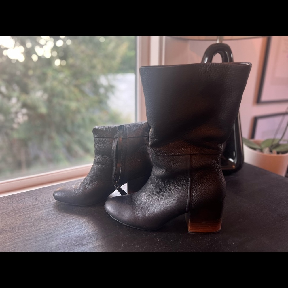 Stylish black mid calf boots.